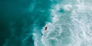 "surfer in break-aerial view"