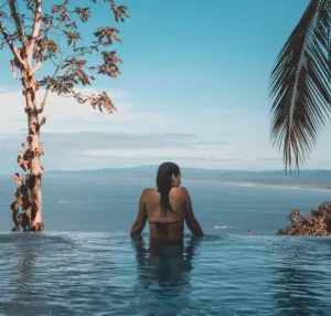 "travel lifestyle-girl in a pool overlooking view"